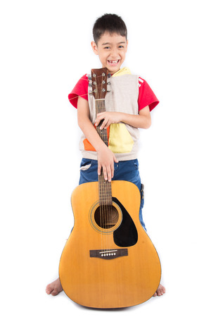 Little boy playing classic guitar on white backgroundの写真素材
