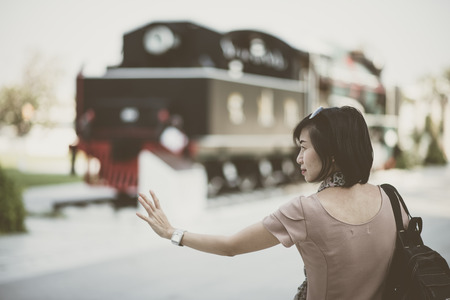 Asian woman waiting for train coming fortravel transportation vintage styleの写真素材