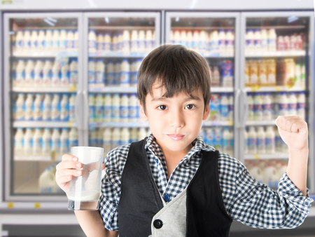 Little boy drinking fresh milk for healthy background of UHT milk storageの写真素材