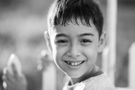 Close up happy face of boy outdoor in the sunset time black and whiteの写真素材