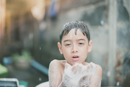Little boy playing water splash at the backyard outdoor activities summer warm timeの写真素材