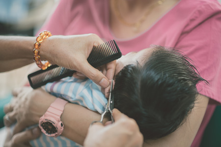 Baby first time hair cutの写真素材