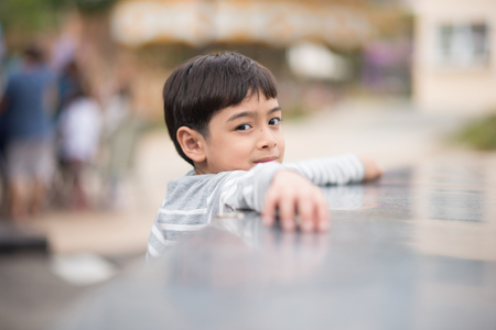 Little boy playing a leaf in the waterの写真素材