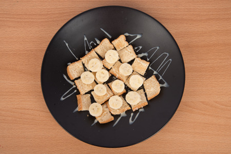 Whole wheat bread with slided banana and  Sweetened condensed milk toppingの写真素材