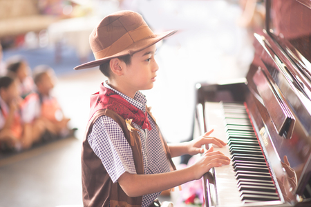 Little boy playing piano outdoor performanceの写真素材