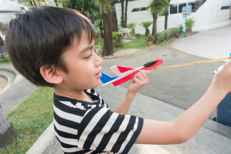 Little boy playing and test how to fly with  plastic airplane science education の写真素材