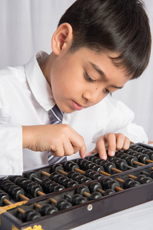 Little boy using abacus to study mathematic education class の写真素材