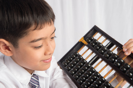 Little boy using abacus to study mathematic education class の写真素材
