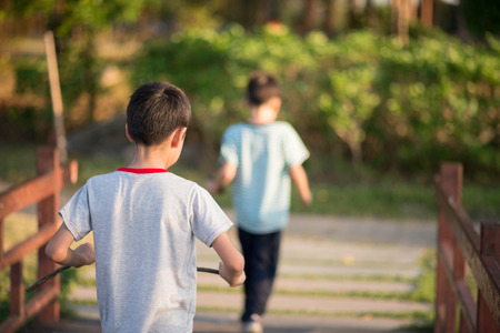 Little boy walking over the bridge in the parkの写真素材