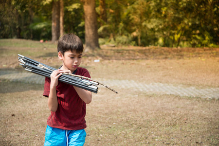 Little boy building a tent for camping with family holiday summer timeの写真素材