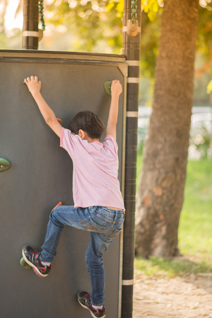 Little boy climbing at playgroundの写真素材