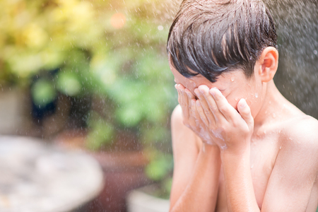 Little boy playing water splashの写真素材