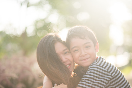 Single mom walking with son together with happy faceの写真素材