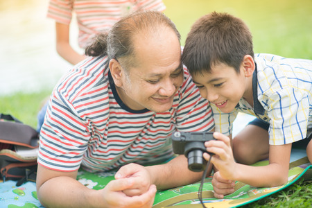 Single father and son taking camera together with happy smile