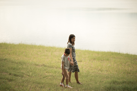 Single mother walking together in the park sunset time happinessの写真素材