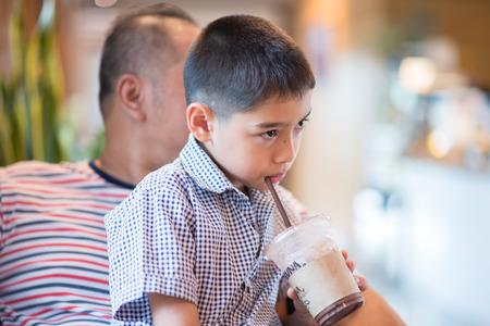 Father and son sitting and talking togetherの写真素材