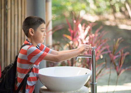 Little boy washing his hands の写真素材