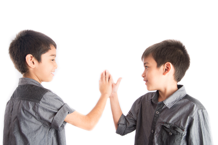 Little sibling boy give me five hand hit togehterの写真素材