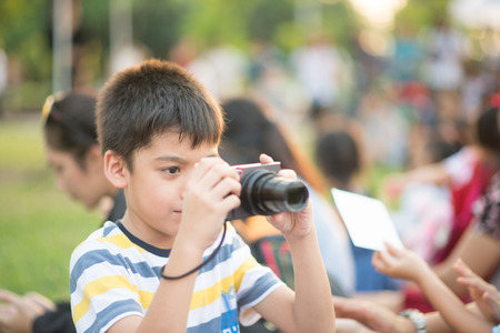 Little  boy look at digital camera after shoot image on travelの写真素材