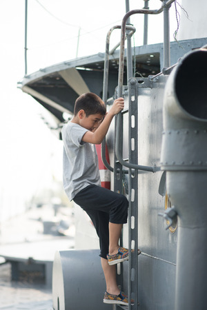 Boy  driving war ship military at the national museamの写真素材