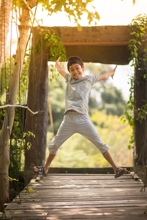 Little boy sitting together over the bridge outdoor activitiesの写真素材