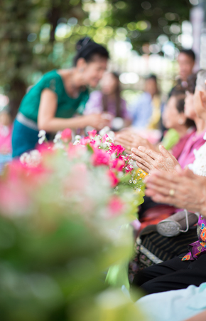 The younger traditionally sprinkle water onto their parents' and grandparents' handsの写真素材