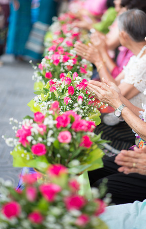 The younger traditionally sprinkle water onto their parents' and grandparents' handsの写真素材
