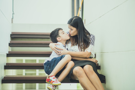 Single mother walking together on the step in the house with happy smileの写真素材