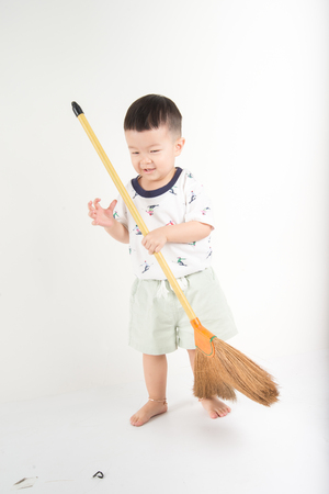 Happy toddler boy jumpping with smile face say Huray on white backgroundの写真素材