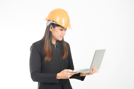 Asian engineer woman working hard on notebook の写真素材