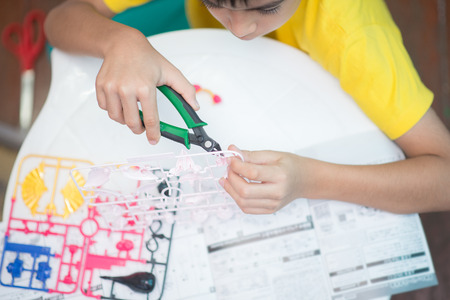 Little boy build model kits toy depicting the vehicles and characters of the fictional