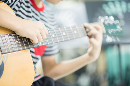 Asian girl studyguitar in the music classroom