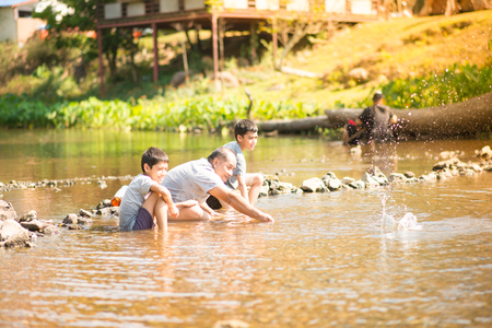 Family travelling at waterfall in the forest happy togetherの写真素材