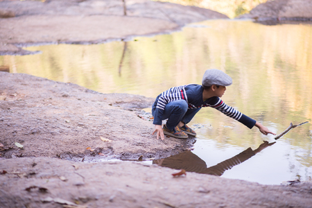 Little Asian boy fishing at the river vintage  retroの写真素材