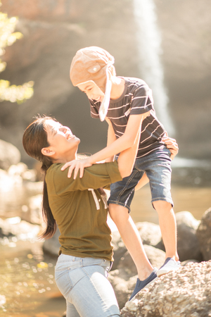 Mother and son hug each other happy together in the forestの写真素材