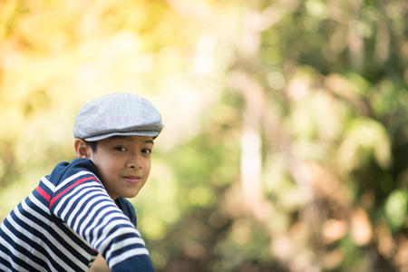 Little boy blow flower floating to the air in the gardenの写真素材