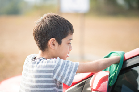 Little boy cleaning carの写真素材