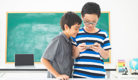 Asian students boy using laptop learning in the classroom at school