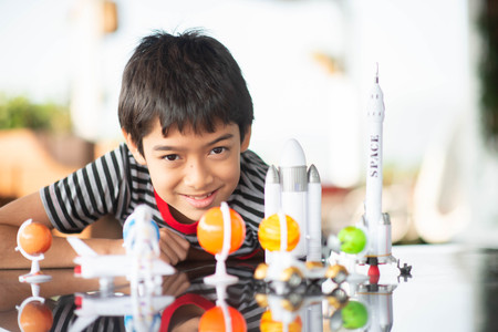 Little boy playing space ship and planet galaxy toyの写真素材