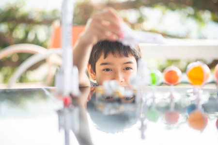 Little boy playing space ship and planet galaxy toyの写真素材