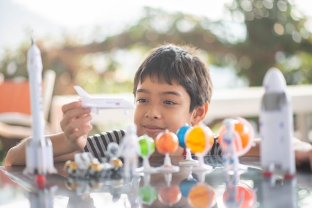 Little boy playing space ship and planet galaxy toyの写真素材
