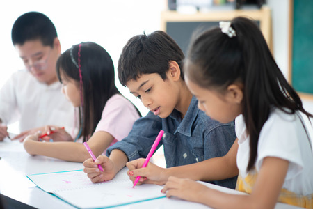 Group of Students study math with teacher in the classroomの写真素材