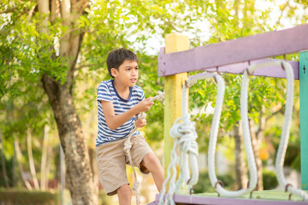 Little boy playing in the playground outdoorの写真素材