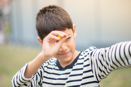 Little boy playing darts board family outdoor activity