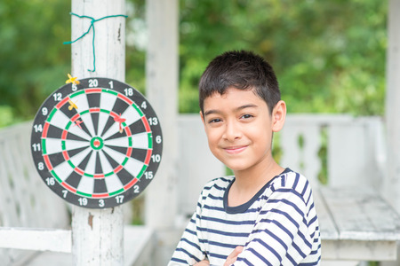 Little boy playing darts board family outdoor activityの写真素材