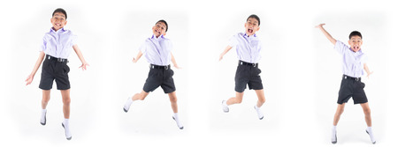 Little Asain boy in student uniform jumping on white background