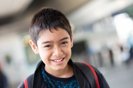 Little boy buying electric ticket and walking in the public sky train station with family 