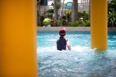 Family having fun at swimming fun park の写真素材