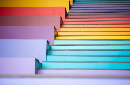 Young boy jumping on the stair rainbow colorful