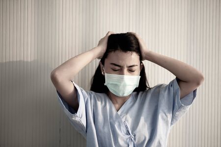 Asian patient woman wearing mask protect virus from sickness in hospitalの写真素材
